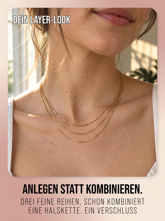 Sundrift in Gold, Nahaufnahme der drei feinen Kettenreihen am Hals